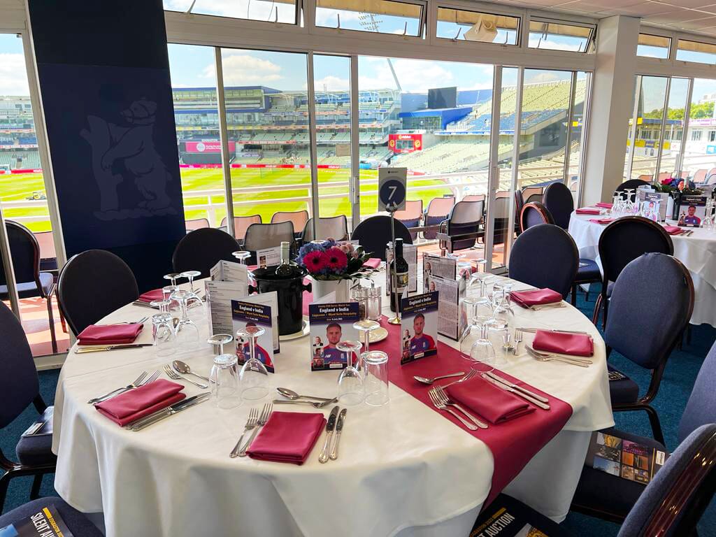 Image of Edgbaston Wyatt Suite including table setup and viewing of the pitch through the glass windows and balcony.